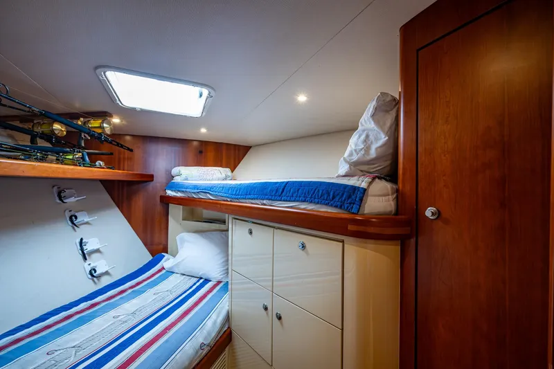 Slide: The Image of Cozy cabin interior of 2008 Ocean Yachts 37 Billfish with bunk beds and fishing rods. - 37