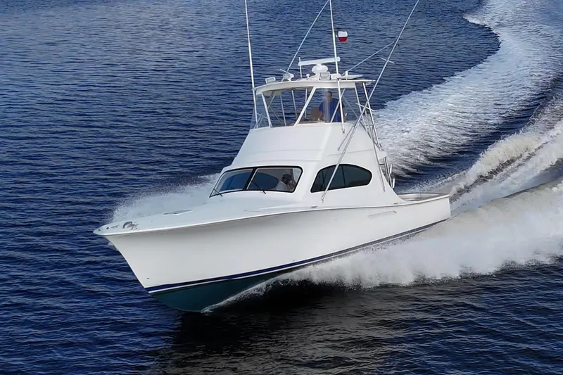 Slide: The Image of 2008 Ocean Yachts 37 Billfish cruising on open water, creating a dynamic wake. - 8