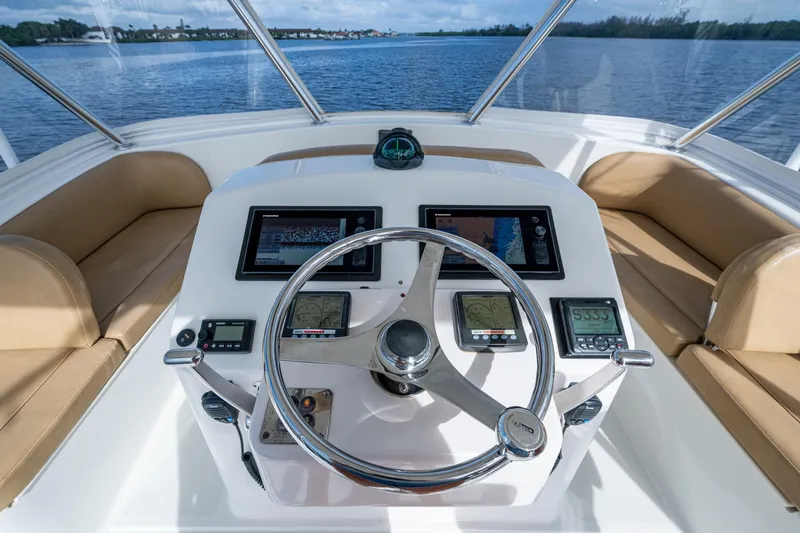 Slide: The Image of Helm of 2008 Ocean Yachts 37 Billfish with navigation equipment and leather seating. - 12