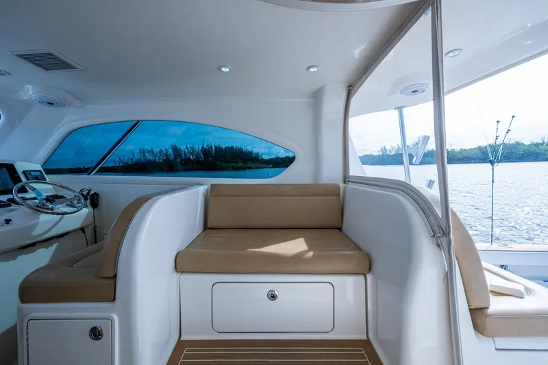 Slide: The Image of Interior of 2008 Ocean Yachts 37 Billfish, featuring seating and helm, overlooking serene waters. - 26