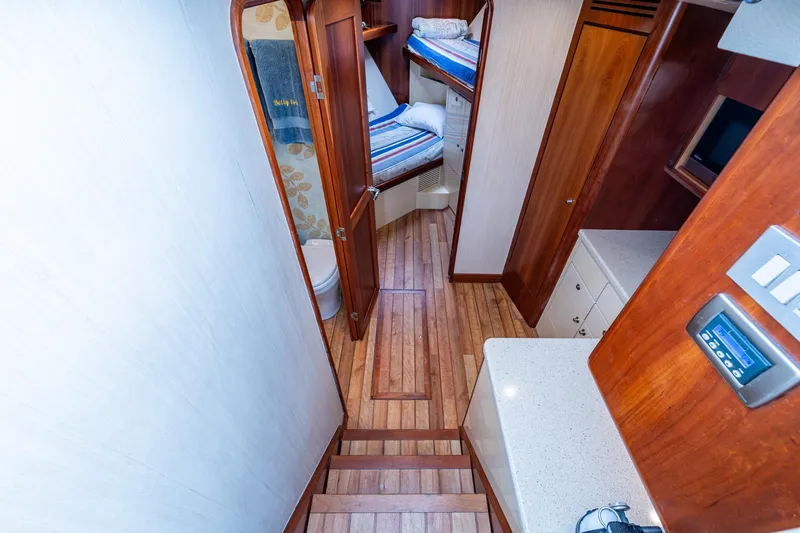 Slide: The Image of Interior of 2008 Ocean Yachts 37 Billfish, featuring wood flooring and cozy cabin space. - 31