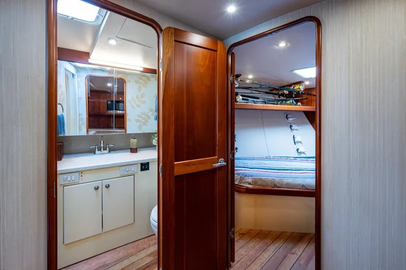 Slide: The Image of Interior of 2008 Ocean Yachts 37 Billfish, featuring bathroom and cabin with fishing rods. - 32