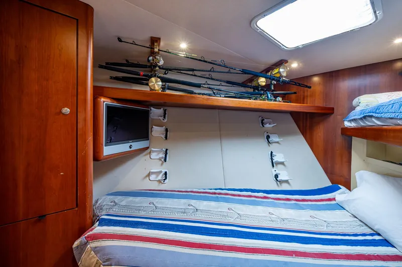 Slide: The Image of Cozy cabin interior of 2008 Ocean Yachts 37 Billfish with fishing rods and TV. - 36