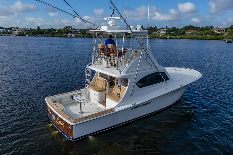 Slide: The Image of 2008 Ocean Yachts 37 Billfish cruising on a serene river under a blue sky. - 4