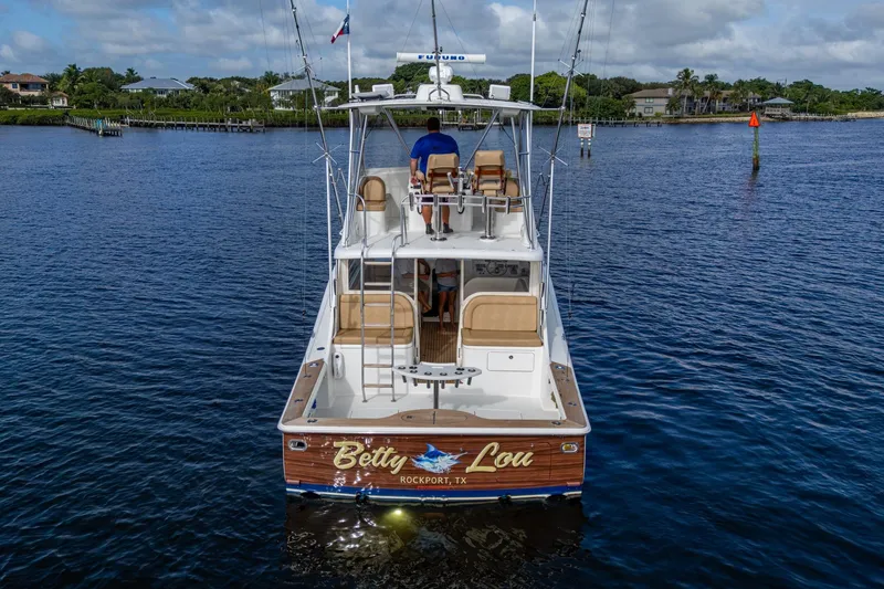 Slide: The Image of 2008 Ocean Yachts 37 Billfish boat on water, rear view, with fishing gear. - 5