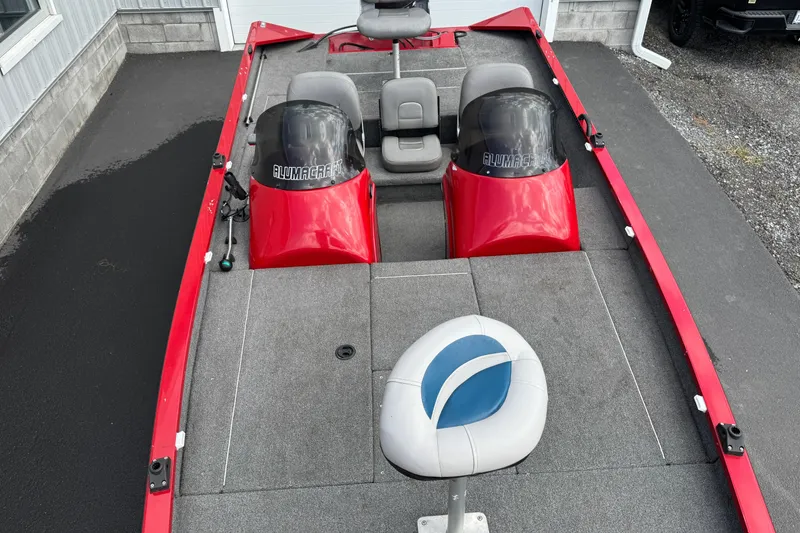 Slide: The Image of 2013 Alumacraft Pro 185 boat with red accents and seating. - 4