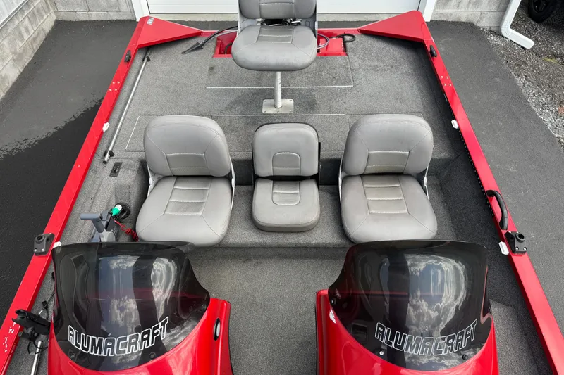Slide: The Image of 2013 Alumacraft Pro 185 boat interior with gray seats and red accents. - 6
