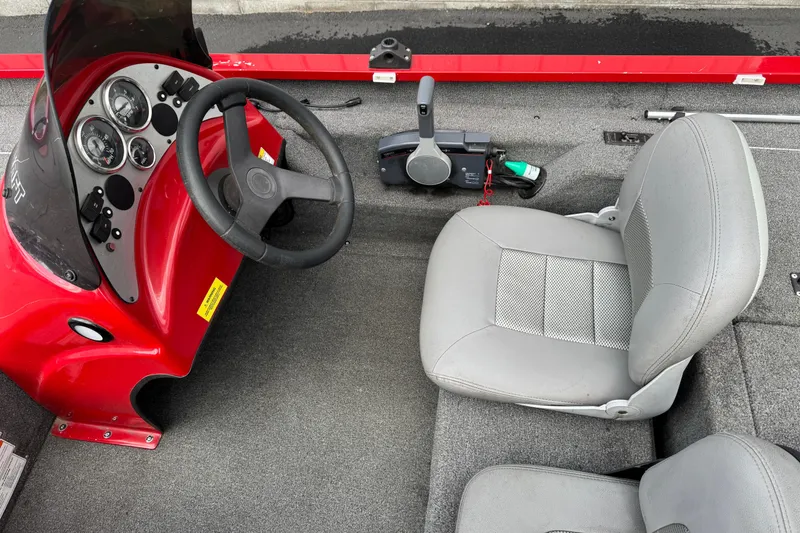 Slide: The Image of 2013 Alumacraft Pro 185 boat interior with steering wheel and gray seating. - 7