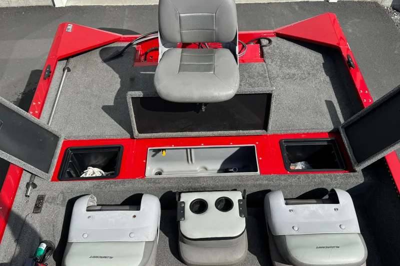 Slide: The Image of 2013 Alumacraft Pro 185 boat interior with red accents and storage compartments. - 9