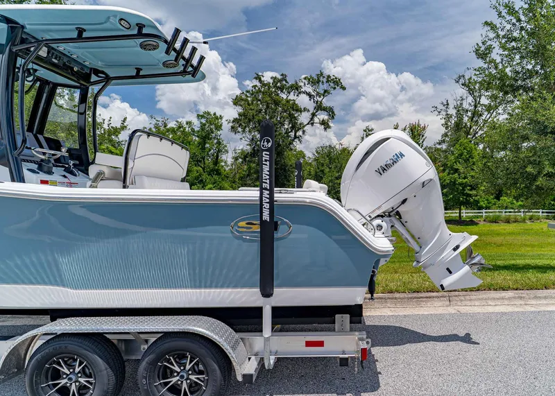 Slide: The Image of 2026 Sea Hunt Ultra 245 SE boat on trailer with Yamaha engine, parked outdoors. - 3