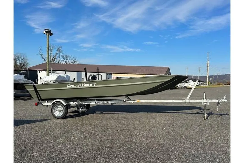 Slide: The Image of 2024 Polar Kraft MV1648 Jon Boat on trailer, parked outdoors under blue sky. - 1