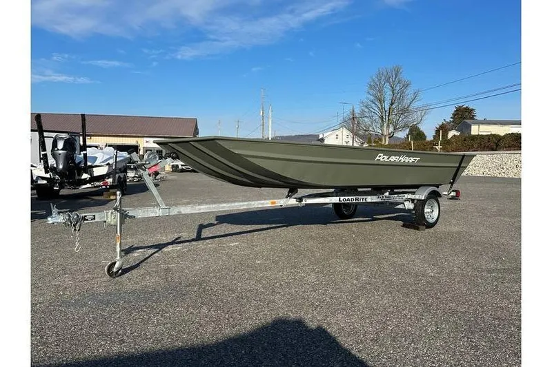 Slide: The Image of 2024 Polar Kraft MV1648 Jon Boat with trailer, parked outdoors under clear sky. - 2