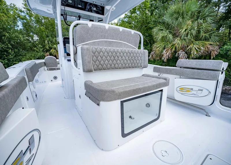 Slide: The Image of 2026 Sea Hunt Ultra 305 SE boat interior with cushioned seating and storage. - 12