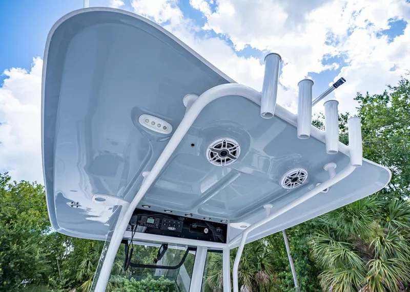 Slide: The Image of 2026 Sea Hunt Ultra 305 SE boat top with rod holders and speakers. - 13