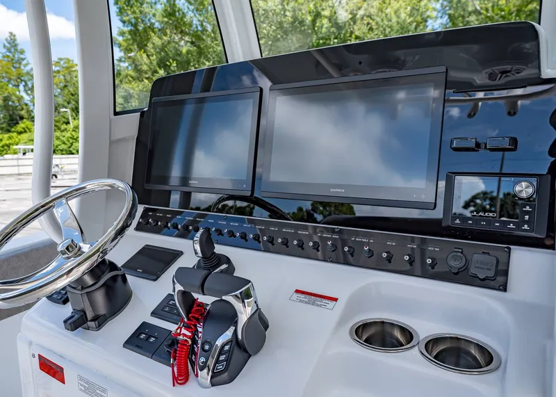 Slide: The Image of 2026 Sea Hunt Ultra 305 SE dashboard with dual screens and controls. - 25