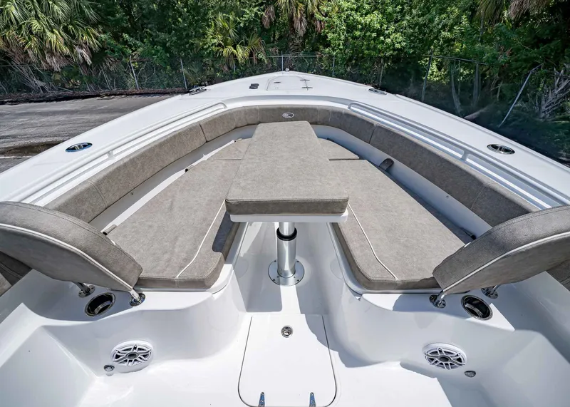 Slide: The Image of 2026 Sea Hunt Ultra 305 SE boat interior with cushioned seating and table. - 36