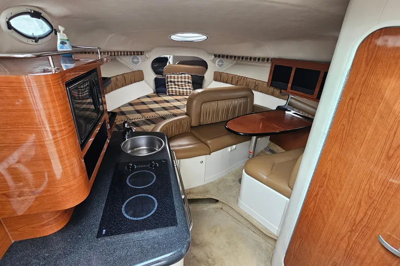 Slide: The Image of 2004 Monterey 282 Cruiser interior with kitchenette, seating, and sleeping area. - 12