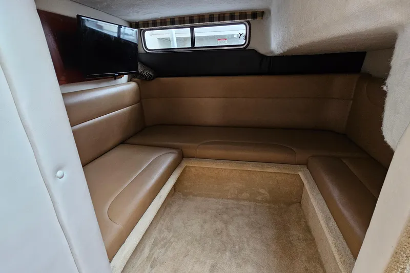 Slide: The Image of Interior cabin of 2004 Monterey 282 Cruiser with brown seating and a mounted TV. - 17