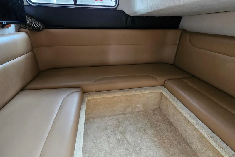 Slide: The Image of 2004 Monterey 282 Cruiser interior with tan leather seating and carpeted flooring. - 18