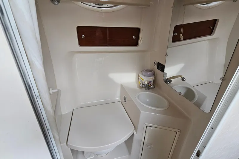 Slide: The Image of 2004 Monterey 282 Cruiser bathroom with sink, mirror, and storage cabinet. - 19