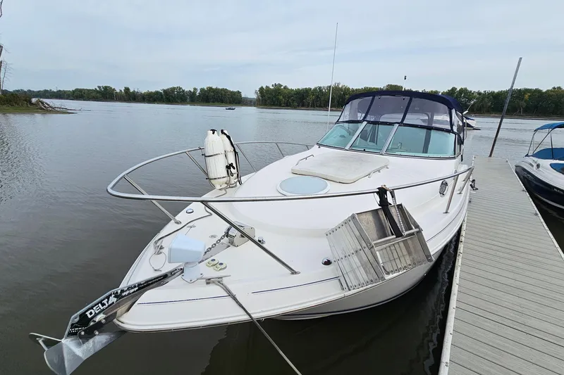 Slide: The Image of 2004 Monterey 282 Cruiser docked on a calm lake with trees in the background. - 3