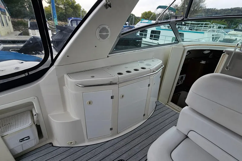 Slide: The Image of 2004 Monterey 282 Cruiser interior with seating and storage, docked at a marina. - 7