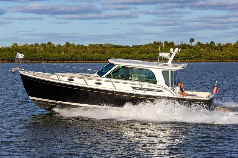 The Image of 2026 Back Cove 372 cruising on calm waters, showcasing sleek design and performance. - 0