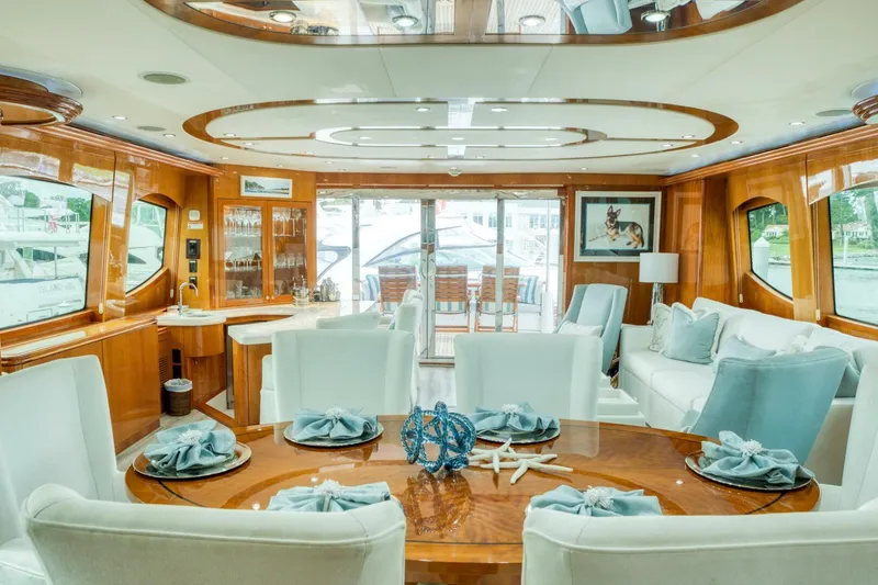 Slide: The Image of Luxurious interior of 2007 Hatteras 80 Enclosed Bridge yacht with elegant dining setup. - 10