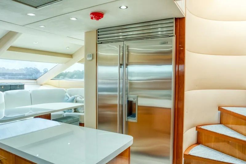 Slide: The Image of Luxurious 2007 Hatteras 80 Enclosed Bridge yacht interior with modern kitchen and stainless steel appliances. - 16