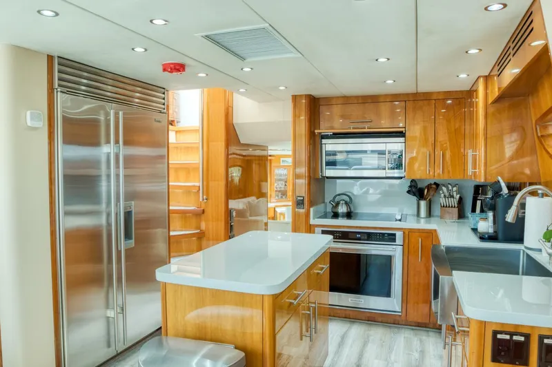 Slide: The Image of Luxurious kitchen interior of 2007 Hatteras 80 Enclosed Bridge yacht, featuring modern appliances. - 20