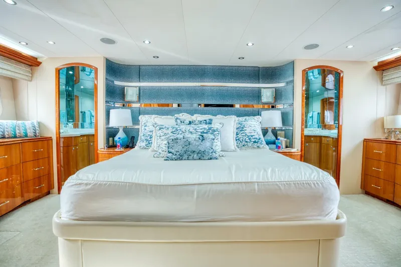 Slide: The Image of Luxurious bedroom interior on 2007 Hatteras 80 Enclosed Bridge yacht, featuring elegant wood accents. - 24