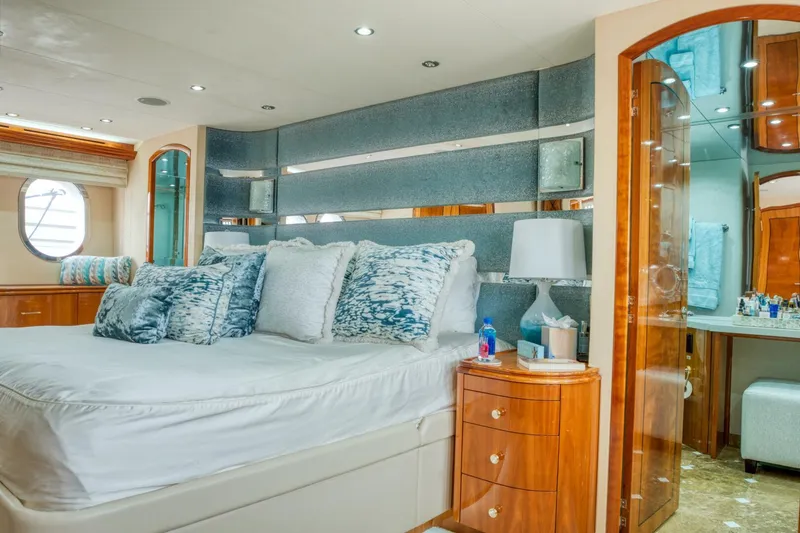 Slide: The Image of Luxurious bedroom interior of 2007 Hatteras 80 Enclosed Bridge yacht with elegant furnishings. - 25