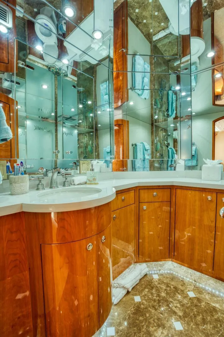 Slide: The Image of Luxurious bathroom on 2007 Hatteras 80 Enclosed Bridge yacht with wood cabinetry and mirrored walls. - 28