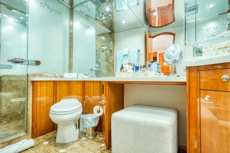 Slide: The Image of Luxurious bathroom in 2007 Hatteras 80 Enclosed Bridge yacht with elegant wood cabinetry and marble flooring. - 31