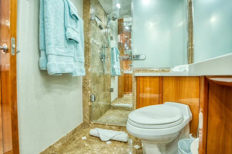 Slide: The Image of Luxurious bathroom on 2007 Hatteras 80 Enclosed Bridge yacht with marble and wood finishes. - 32