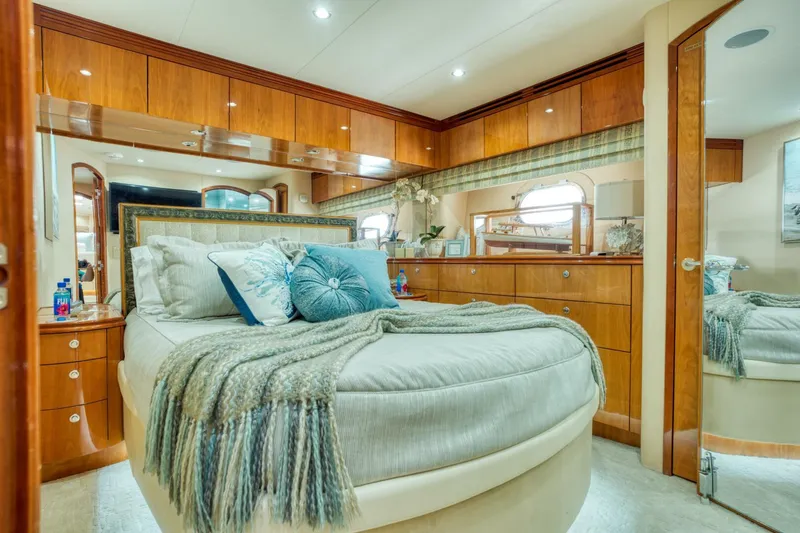 Slide: The Image of Luxurious bedroom interior of 2007 Hatteras 80 Enclosed Bridge yacht with elegant wood finishes. - 33