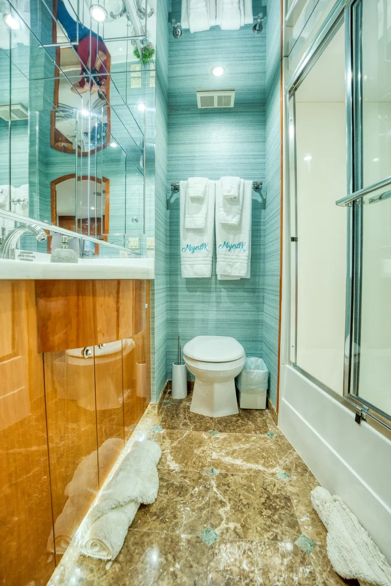 Slide: The Image of Luxurious bathroom on 2007 Hatteras 80 Enclosed Bridge yacht with marble flooring and modern fixtures. - 36