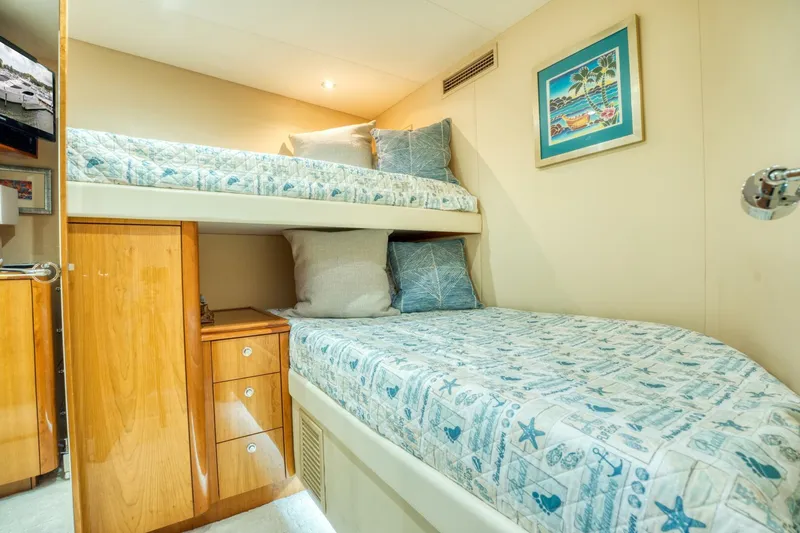 Slide: The Image of Bunk beds in 2007 Hatteras 80 Enclosed Bridge yacht cabin, featuring nautical-themed bedding. - 41