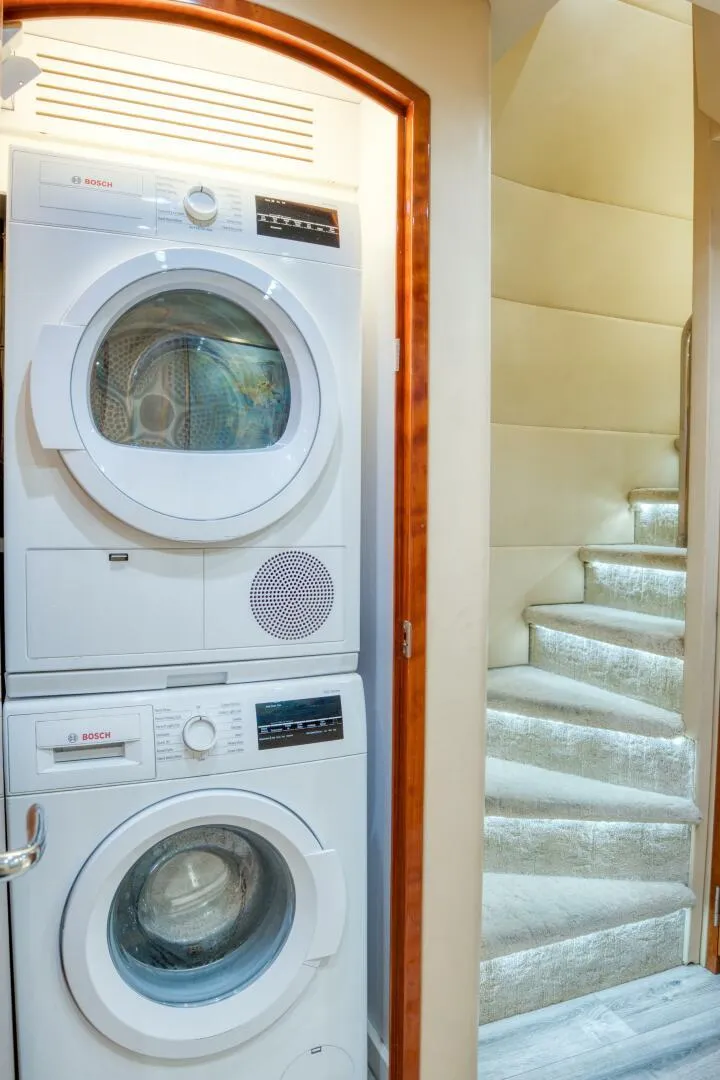Slide: The Image of Stacked washer and dryer in 2007 Hatteras 80 Enclosed Bridge yacht interior. - 44