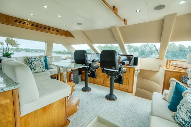 Slide: The Image of Luxurious interior of 2007 Hatteras 80 Enclosed Bridge yacht with plush seating and helm. - 45