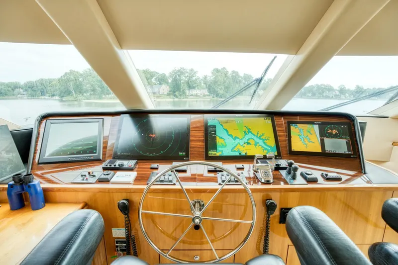 Slide: The Image of Helm of 2007 Hatteras 80 Enclosed Bridge yacht with navigation screens and steering wheel. - 47
