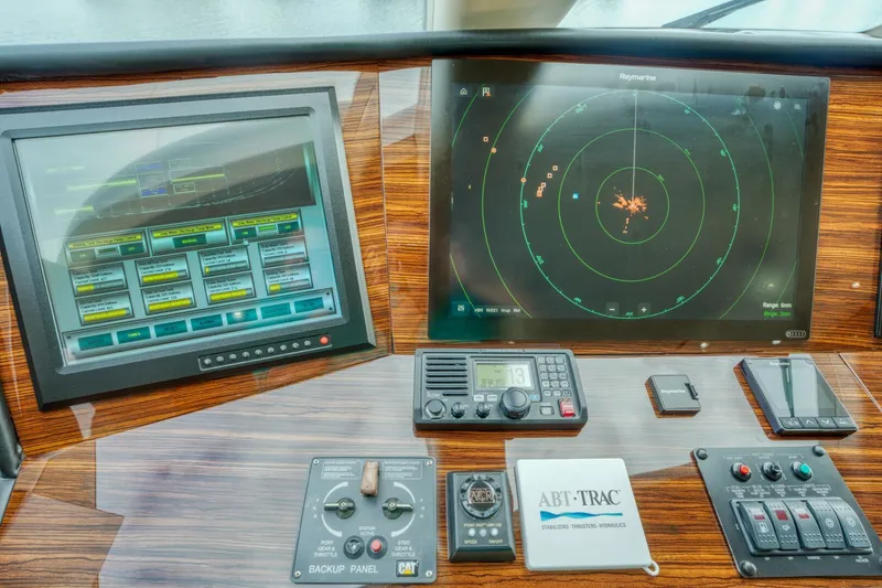 Slide: The Image of Control panel of 2007 Hatteras 80 Enclosed Bridge yacht with navigation screens. - 48