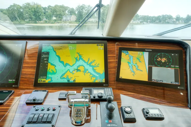 Slide: The Image of Control panel of 2007 Hatteras 80 Enclosed Bridge yacht with navigation screens and controls. - 49