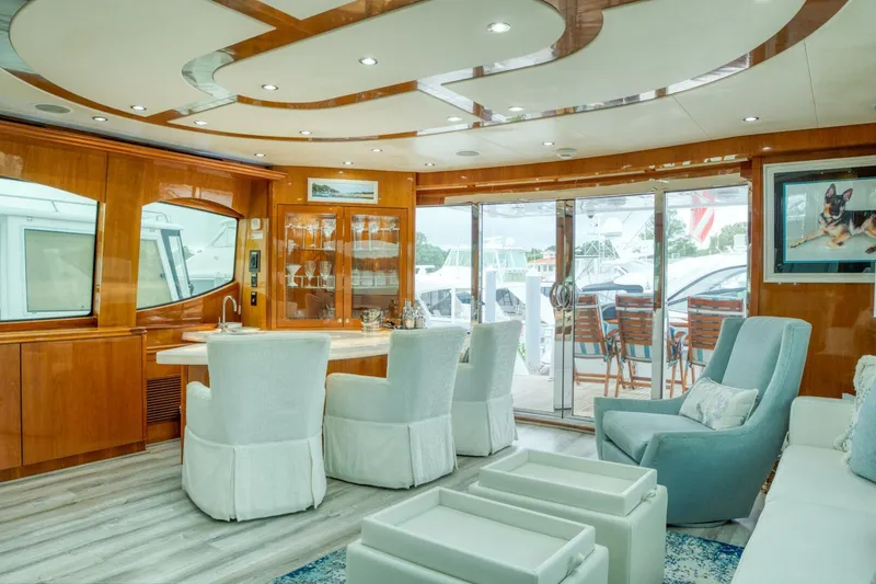 Slide: The Image of Luxurious interior of 2007 Hatteras 80 Enclosed Bridge yacht with elegant seating and wood finishes. - 7