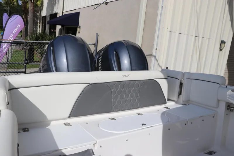 Slide: The Image of 2020 Tidewater 252 LXF boat with dual Yamaha engines, docked outdoors. - 10