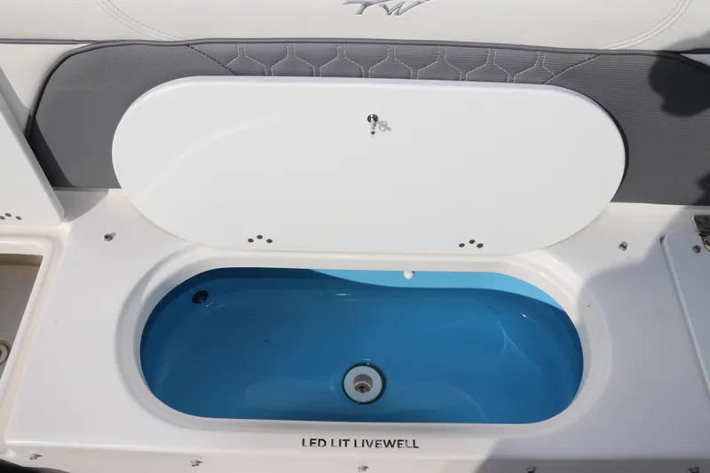 Slide: The Image of 2020 Tidewater 252 LXF boat with LED-lit livewell open. - 13