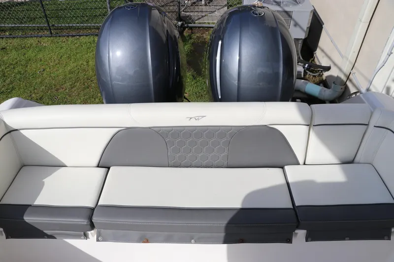 Slide: The Image of 2020 Tidewater 252 LXF boat with dual outboard engines and cushioned seating. - 14
