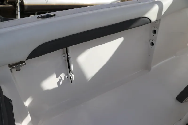 Slide: The Image of 2020 Tidewater 252 LXF boat interior detail with cup holder and sleek design. - 17