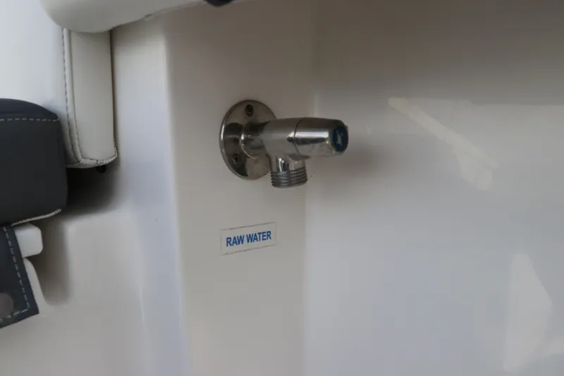 Slide: The Image of Raw water outlet on 2020 Tidewater 252 LXF boat, featuring stainless steel fitting. - 18