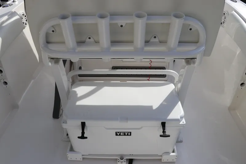 Slide: The Image of 2020 Tidewater 252 LXF boat interior with rod holders and Yeti cooler. - 19